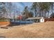 Spacious backyard featuring a pool with large deck, storage and privacy fence at 31 Pecan Lake Ct, Sharpsburg, GA 30277