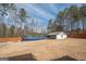 Expansive backyard featuring a fenced pool and storage shed in a wooded setting at 31 Pecan Lake Ct, Sharpsburg, GA 30277
