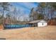 Outdoor living with a large above-ground pool, outbuilding and sprawling backyard at 31 Pecan Lake Ct, Sharpsburg, GA 30277