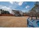 Spacious backyard with a deck, patio, wooden fence, trees, and outdoor living space at 31 Pecan Lake Ct, Sharpsburg, GA 30277