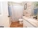 Charming bathroom with wood-look plank accents, neutral countertop, and decorative shower curtain at 31 Pecan Lake Ct, Sharpsburg, GA 30277