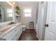 Stylish bathroom showcasing double vanity, shelving, and tub with shower at 31 Pecan Lake Ct, Sharpsburg, GA 30277