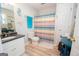 Bathroom featuring colorful shower curtain, starfish accents and a large vanity at 31 Pecan Lake Ct, Sharpsburg, GA 30277