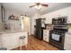 Modern kitchen with white cabinets, stainless steel appliances, and wood floors at 31 Pecan Lake Ct, Sharpsburg, GA 30277