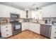 Modern kitchen featuring stainless steel appliances and stylish white cabinets at 31 Pecan Lake Ct, Sharpsburg, GA 30277