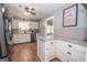 Spacious kitchen with white cabinets, tile backsplash, and granite countertops at 31 Pecan Lake Ct, Sharpsburg, GA 30277