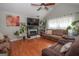 Bright living room featuring hardwood floors, fireplace, and comfortable seating at 31 Pecan Lake Ct, Sharpsburg, GA 30277