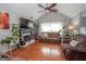 Bright living room featuring hardwood floors, fireplace, and comfortable seating at 31 Pecan Lake Ct, Sharpsburg, GA 30277