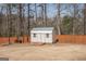 Backyard shed and privacy fence in a naturally landscaped yard at 31 Pecan Lake Ct, Sharpsburg, GA 30277