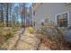 Landscaped backyard with stone pathway leading towards privacy in the wooded areas at 339 Kensington Dr, Peachtree City, GA 30269