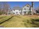 Large backyard with patio featuring a multi-story home with detailed window designs at 339 Kensington Dr, Peachtree City, GA 30269