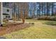 Backyard with paver patio, an outdoor dining set, and manicured grass at 339 Kensington Dr, Peachtree City, GA 30269