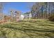 Expansive backyard featuring a lush lawn and a greenhouse next to a two-story home at 339 Kensington Dr, Peachtree City, GA 30269