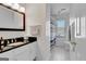 Clean bathroom featuring white cabinets, black countertops, and tile flooring at 339 Kensington Dr, Peachtree City, GA 30269