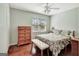 Bright bedroom featuring hardwood floors, a ceiling fan, and a comfortable bed at 339 Kensington Dr, Peachtree City, GA 30269