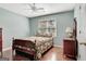 Cozy bedroom featuring hardwood floors and a comfortable bed with a paisley comforter at 339 Kensington Dr, Peachtree City, GA 30269