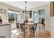 Inviting dining area with a round table, stylish chandelier, and scenic views of the backyard at 339 Kensington Dr, Peachtree City, GA 30269