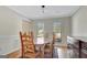 Bright dining room featuring hardwood floors, a wood table, and large windows offering plenty of natural light at 339 Kensington Dr, Peachtree City, GA 30269