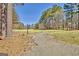 Community entrance features a winding paved driveway in a pastoral setting at 339 Kensington Dr, Peachtree City, GA 30269