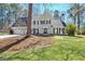 Traditional two-story home featuring a manicured lawn, two-car garage, and charming facade with black shutters at 339 Kensington Dr, Peachtree City, GA 30269