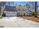 Traditional two-story home featuring a manicured lawn, two-car garage, and charming facade with black shutters at 339 Kensington Dr, Peachtree City, GA 30269