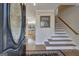 Inviting foyer showcasing hardwood floors, elegant staircase, and views of the living spaces beyond at 339 Kensington Dr, Peachtree City, GA 30269