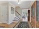 Inviting foyer with hardwood floors, staircase, wooden front door, and elegant accents showcasing a warm welcome at 339 Kensington Dr, Peachtree City, GA 30269