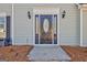 Close-up of the front entrance highlighting an elegant black door with decorative glass and sconces at 339 Kensington Dr, Peachtree City, GA 30269