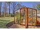 Greenhouse with shelving contains healthy plant growth at 339 Kensington Dr, Peachtree City, GA 30269