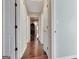 Hallway view with hardwood floors and white doors that highlight natural light at 339 Kensington Dr, Peachtree City, GA 30269