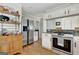Kitchen featuring stainless steel appliances, granite countertops, and custom cabinetry at 339 Kensington Dr, Peachtree City, GA 30269