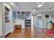 Open living room with hardwood floors, a ceiling fan, and built-in bookcases at 339 Kensington Dr, Peachtree City, GA 30269