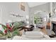 Bright living room with vaulted ceiling, brick fireplace, leather sofa, and access to an outdoor patio at 339 Kensington Dr, Peachtree City, GA 30269