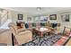 Living room featuring a large sectional sofa, area rug and views into other rooms at 339 Kensington Dr, Peachtree City, GA 30269