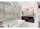 Luxurious bathroom featuring an integrated soaking tub and vanity with dark cabinetry at 339 Kensington Dr, Peachtree City, GA 30269