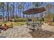 A backyard stone patio is set for outdoor dining at 339 Kensington Dr, Peachtree City, GA 30269