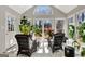 Bright sunroom with tile flooring, large windows, comfortable seating, and lush greenery, creating a tranquil space at 339 Kensington Dr, Peachtree City, GA 30269