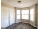 Sunny bedroom boasts new gray flooring, ample natural light with a nice bay window, and a closet at 5345 Bridle Point Pkwy, Snellville, GA 30039