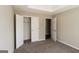 An empty carpeted bedroom featuring a closet and an open doorway at 5345 Bridle Point Pkwy, Snellville, GA 30039