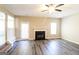 Open living room with a fireplace, wood-look flooring, and access to the backyard at 5345 Bridle Point Pkwy, Snellville, GA 30039