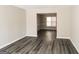 Bright living room with neutral walls, gray wood-look flooring and an open floor plan at 5345 Bridle Point Pkwy, Snellville, GA 30039