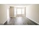 Bright living room with wood-look floors and a sunny bay window at 5345 Bridle Point Pkwy, Snellville, GA 30039