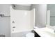 Bathroom with a shower and tub combination, modern gray walls, and updated fixtures at 7569 Bowhead Ct, Fairburn, GA 30213