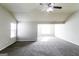 Spacious bedroom features a ceiling fan and plush carpeting, offering a cozy and inviting atmosphere at 7569 Bowhead Ct, Fairburn, GA 30213
