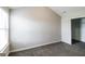 A spacious bedroom with a large closet, neutral gray walls and plush gray carpet at 7569 Bowhead Ct, Fairburn, GA 30213