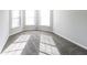 Bedroom with three windows letting in plenty of natural light, gray walls, and gray carpet at 7569 Bowhead Ct, Fairburn, GA 30213