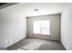 Bedroom with neutral walls, carpet, and a window letting in sunlight at 7569 Bowhead Ct, Fairburn, GA 30213