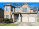 Charming brick two-story home with a well-manicured lawn and a two-car garage with decorative shutters at 7569 Bowhead Ct, Fairburn, GA 30213