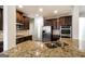 Gourmet kitchen boasts granite countertops, stainless steel appliances, and ample cabinet space for storage at 7569 Bowhead Ct, Fairburn, GA 30213