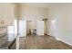 View from kitchen toward a bathroom with white doors, sink, toilet and wood-look flooring at 6290 Shallowford Way, Douglasville, GA 30135